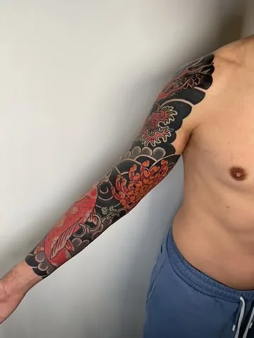 Japanese koi and chrysanthemum sleeve — traditional tattoo by Alex Roze, Kelowna