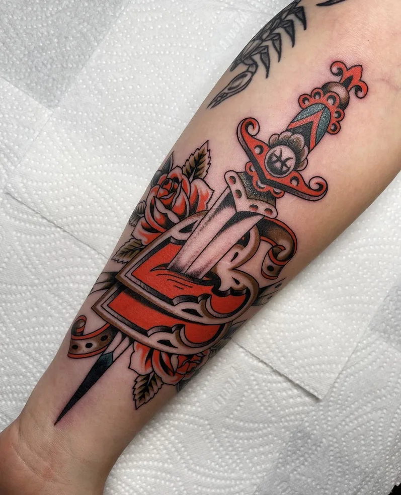 Dagger through a rose — traditional tattoo by Alex Roze, Kelowna