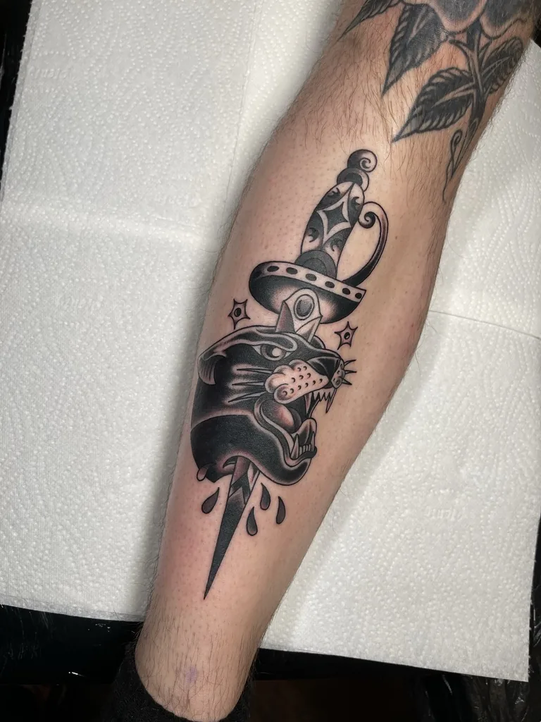 Panther head and dagger — traditional tattoo by Alex Roze, Kelowna