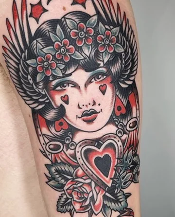 Woman with winged headdress, flowers and heart — traditional tattoo by Alex Roze, Kelowna