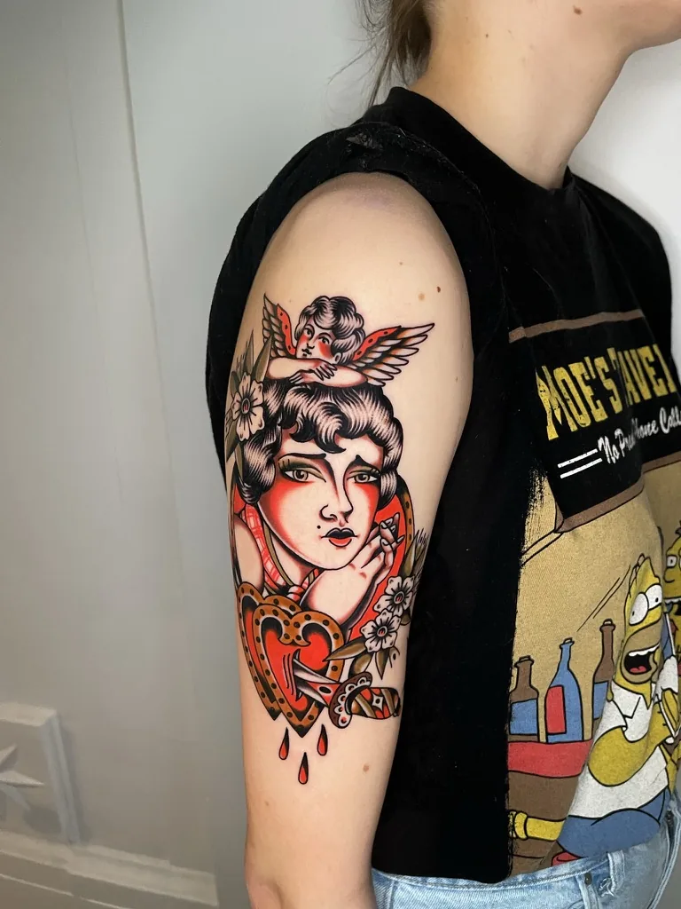Woman with cherub and heart pierced by a dagger — traditional tattoo by Alex Roze, Kelowna