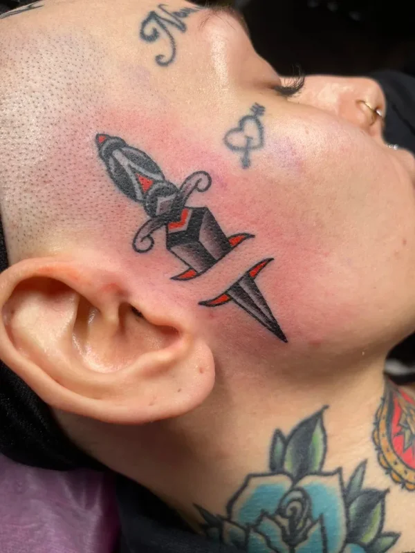 Dagger on the face. Tattoo by Alex Roze.