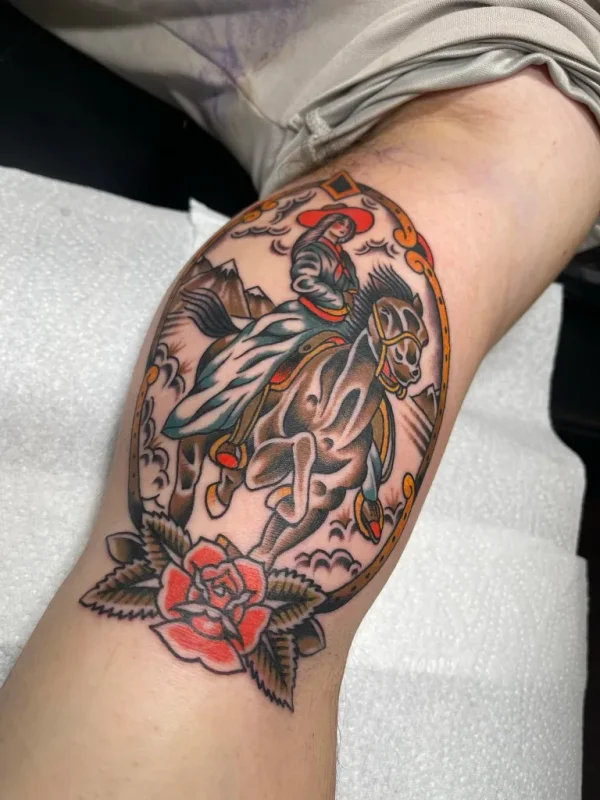 Cowgirl on a rearing horse with rose. Tattoo by Alex Roze.