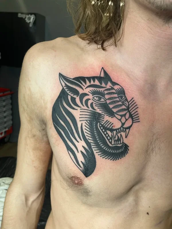 Tiger head on the chest. Tattoo by Alex Roze.