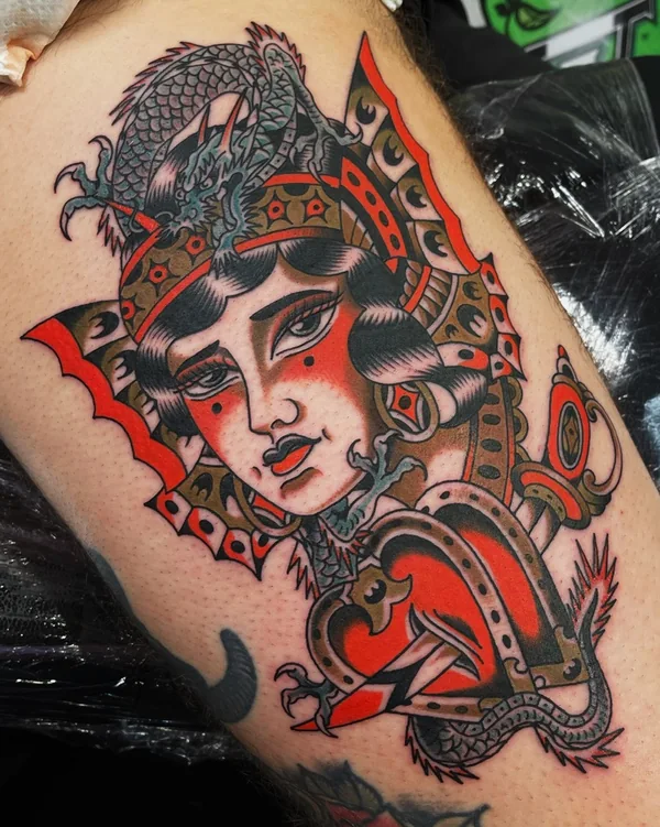 Lady head in a red helmet with dragon details and bold black shading. Tattoo by Alex Roze.